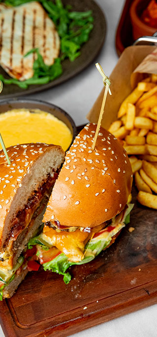 burger-with-tomatoes-lettuce-cheese-served-with-french-fries